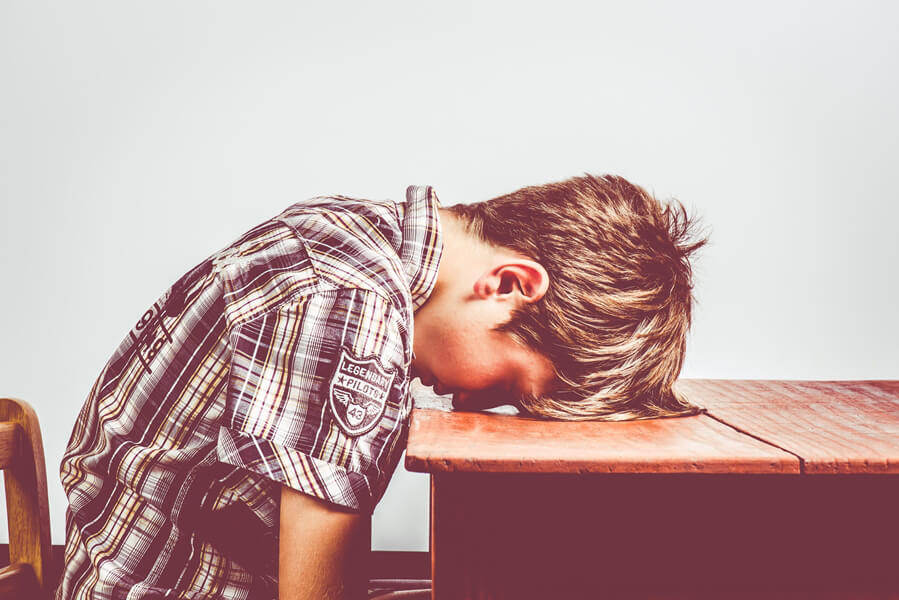 child with head on the table