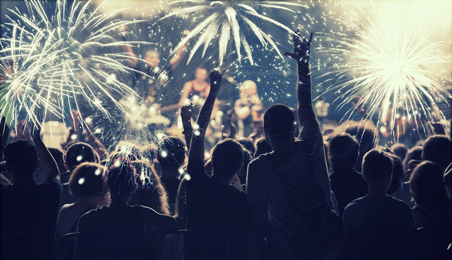 Cheering crowd and fireworks at New Year's Eve
